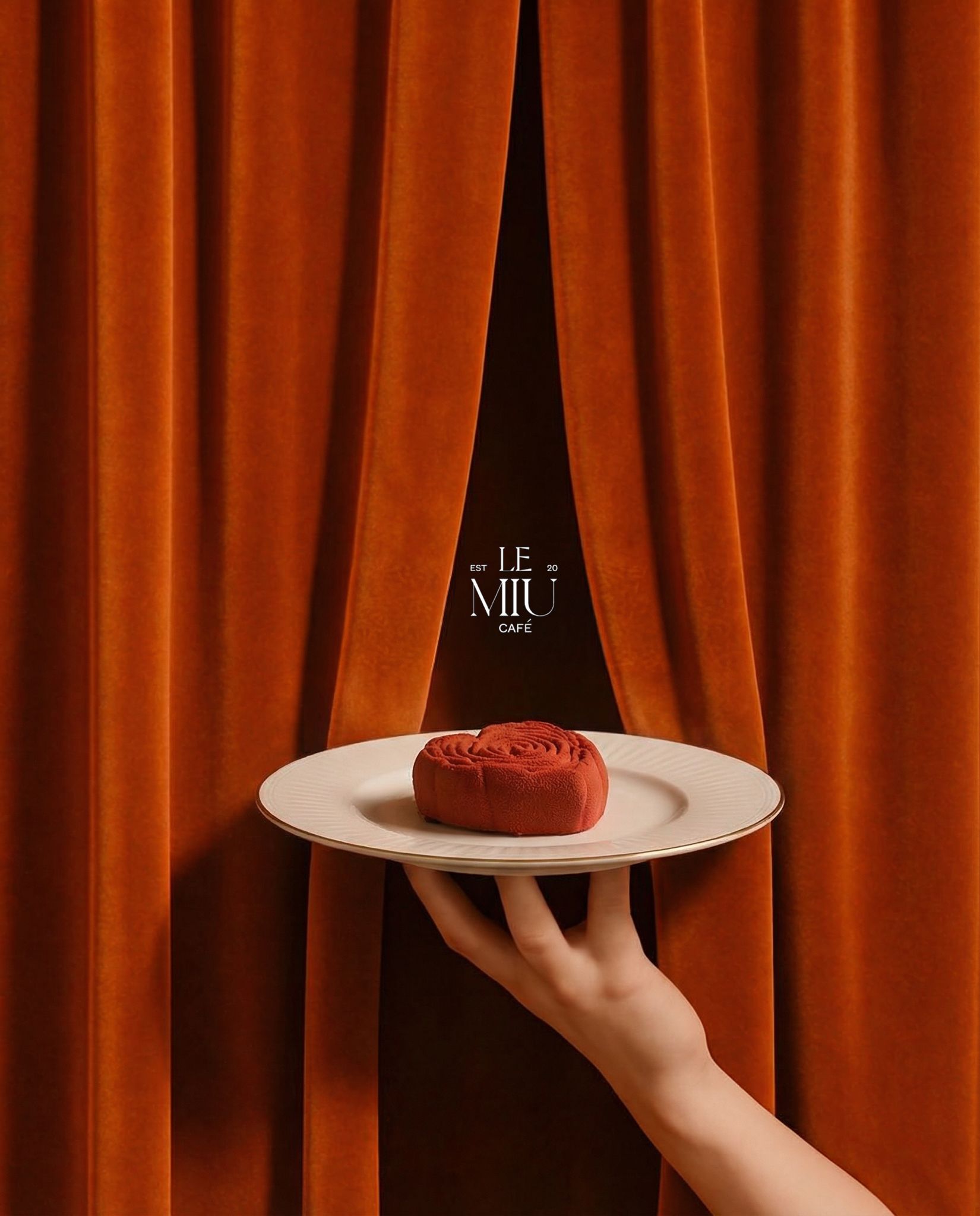 Red velvet entremet served between velvet curtains
